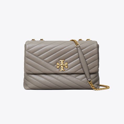 The Kira Convertible Shoulder Bag is made of soft chevron-quilted leather with beveled Double T hardware. An adjustable chain strap adapts in the moment — doubled over the shoulder, or long and crossbody. Kira Chevron Convertible Shoulder Bag, Tory Burch Kira Chevron, Kira Chevron, Tory Burch Purse, Tory Burch Crossbody, Tory Burch Kira, Womens Designer Handbags, Leather Roll, Tory Burch Handbags