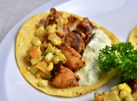 Finally getting the opportunity to work with alligator, I wanted to do a Louisiana mash-up that only a kid from Ontario would dare. Blackened gator, maque choux, and remoulade sauce all seemed like good bedfellows, but I decided to go further and jam them all into corn tortillas for Bayou-style tacos. These totally untraditional tacos are a bit wacky, but they taste great and are a wonderful way to enjoy the very unique alligator meat!Note: some blackening spice blends can be very salty, so ... Alligator Tacos Recipes, Alligator Dipping Sauce, Alligator Food Ideas, Louisiana Alligator, Corn Maque Choux Cajun, Alligator Meat, Sausage Tacos, Blackening Spice, Louisiana Hot Sauce