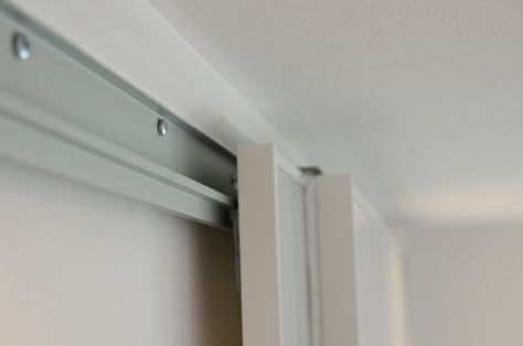 Ikea Pax hack: Notice the height of the screws along the top track allowing the casters to roll without obstruction. Barn door idea? Ikea Sliding Door, Pax Hack, Ikea Pax Hack, Gambrel Style, Ikea Closet, Closet Hacks, Ikea Hackers, Sliding Closet Doors, Ikea Pax