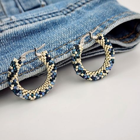 Denim Beaded Hoop Earrings Mesmerizing Light-Reflecting Effect      Looking for earrings that match perfectly with your favorite jeans or jean jacket? These denim beaded hoop earrings are created especially for denim lovers. Made with unique silk satin beads, they shine beautifully and reflect light from different angles, creating a captivating effect. Crafted using six types of beads to mimic denim fabric but with varied textures, these earrings look even better in person, with a fantastic shin Shiny Earrings, Multicolor Earrings, Pad Bag, Beaded Jewlery, Beaded Jewelry Patterns, Beaded Hoop Earrings, Beaded Hoops, Fun Fashion, Seed Bead Earrings