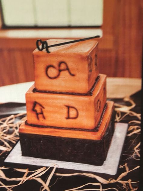 My brother's groom's cake was too cute not to share! Every bit of the cake was edible from the leather look around the bottom to the branding iron on top. The brands on the sides are all brands from the bride and grooms families. #weddingcake #rusticwedding #groomscake Ranch Cakes For Men, Western Grooms Cake Ideas, Cowboy Grooms Cake, Western Grooms Cake, Ranch Wedding Cake, Farmer Grooms Cake, Groomsmen Cake Ideas, Cow Grooms Cake, Cowboys Grooms Cake