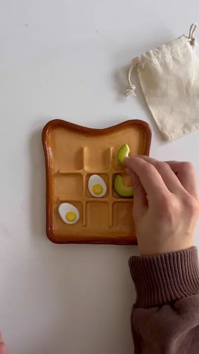 avo & egg toast board for the breakfast collection dropping June 1st a... | tic tac toe clay | TikTok Toast Board, Clay Modelling, Tic Tac Toe Board, Travel Crafts, Diy Air Dry Clay, Air Dry Clay Projects, Kids Pottery, Egg Toast, Tic Tac Toe Game