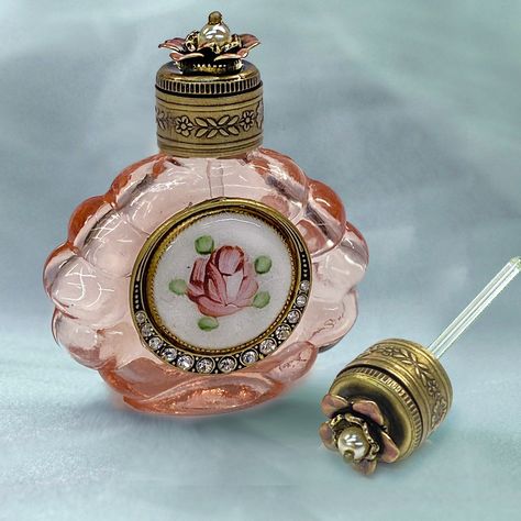 Decant a favorite scent or essential oil into this vintage perfume bottle to carry with you or display on your vanity.In translucent pink glass, the scalloped shape is pressed from the original 70 year old molds. The metal work features a vintage circa 1940s cloisonne rose enamel disk encircled by a graduated border of premium crystal. The top is mounted with a dimensional vintage metal rose, centered with a pearl. Glass dauber stem is attached inside the top for application of fragrance. Finish Mini Parfum, Mini Perfume, Hippie Wedding, Rose Essential Oil, Essential Oil Bottles, Rose Vintage, Scent Bottle, Vintage Perfume Bottles, Glass Candy