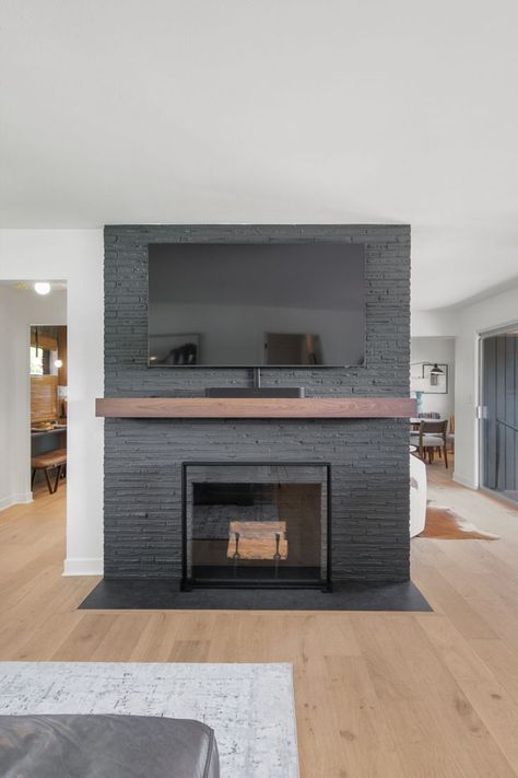 This existing fireplace was updated with a fresh coat of Sherwin-Williams Iron Ore (SW 7069). Iron Ore Mantle, Iron Ore Sherwin Williams Fireplace, Iron Ore Fireplace, Iron Ore Paint, Iron Ore Sherwin Williams, Whole House Remodel, Paint Fireplace, Kitchen Bathroom Remodel, Iron Ore