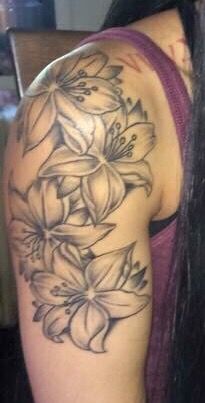 Lilly Flower Tattoo Designs Shoulder, Surprise Lily Tattoo, Shoulder Flower Tattoos For Women Black, Lilly Shoulder Tattoos For Women, Lily Shoulder Tattoos For Women, Lily Flower Tattoos Shoulder, Lily Hand Tattoo, Lily Shoulder Tattoo, Lily Tattoos For Women