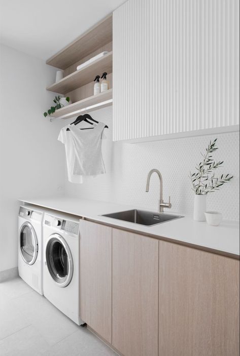 Classic finishes were used to create this Coastal Laundry Room, including White panelled overhead cupboards and benchtop, paired with Oak cabinetry and open shelves. Brushed nickel mixer tap and white penny round tiles complete the look. Follow us on Instagram and Pinterest for all the latest home design, tips, trends and products. #laundry #laundryroomideas #laundryroomdesign #pennyrounds #whitekitchenideas #shelves #paneling #oakkitchencabinets Laundry Makeover, Dream Laundry Room, Laundry Room Layouts, Laundry Room Renovation, Laundry Design, Modern Laundry Rooms, Laundry Room Inspiration, Laundry Room Remodel, Contemporary Coastal