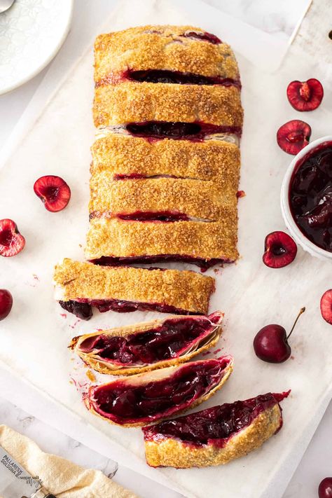 Flaky puff pastry stuffed with a fresh, tart cherries – what could be better than this easy puff pastry cherry strudel for a fruity dessert. A slice of this cherry pastry, still warm from the oven, with a scoop of ice cream is irresistible. Plump juicy cherries, cooked and softened in juice then stuffed into pastry and baked to crispy golden perfection. This easy strudel recipe will become a family favourite. #sugarsaltmagic #strudel #cherries #pastries Cherry Strudel Recipe, Cherry Pastry, Cherry Strudel, Fruity Dessert, Strudel Recipes, Custard Tarts, Tart Cherries, Easy Puff, Baking Lessons