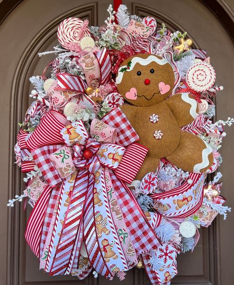 Say Hello to the Holidays with a Gingerbread welcoming you home.  Dress up your front door or wall with this fun one of a kind whimsical Gingerbread and Peppermint Candy cane Christmas wreath. Let the vibrant pinks and reds welcome in the holiday season!  Your neighbors will wish they had one. This wreath is made with premium materials and is the perfect décor for the holiday season. It is made on a ever green wreath form base with layers of mesh, ribbon, holiday picks, and an elaborate bow to a Ginger Bread Christmas Wreath, Christmas Wreaths Pink, Gingerbread Wreaths, Grave Arrangements, Gingerbread Christmas Wreath, Christmas Entrance, Christmas Candy Cane Decorations, Crafts 2024, Pink Christmas Wreath