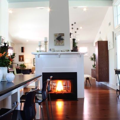 see through center of room fireplaces | Free standing see through fireplace-dining to family ... | For the Ho ... Standing Fireplace, Interior Minimal, Double Sided Fireplace, Eclectic Kitchen, Corner Fireplace, Kitchen Fireplace, Family Room Design, Fireplace Design, Contemporary Living Room