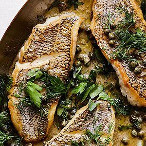 Black Sea Bass With Capers and Herb-Butter Sauce | Martha Stewart Black Sea Bass Recipe, Sauteed Fish, Sea Bass Recipes, New Years Eve Dinner, Fish Fillets, New Year's Eve Recipes, White Fish, Herb Butter, Sea Bass