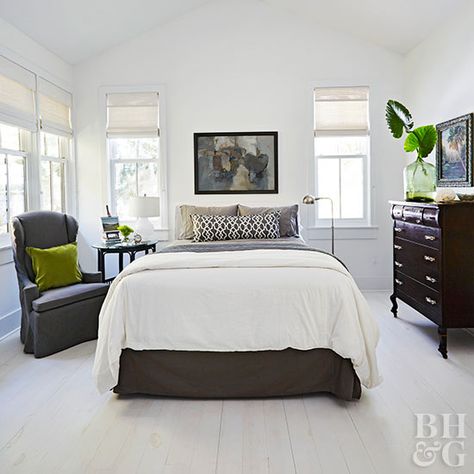 Ground an all-white space with black accents for a contemporary look. This all-white bedroom idea (floors, walls, and ceiling) enlists the help of a charcoal bed skirt and dark wood furniture to ground the decor. #bedroom #homedecor #bhg White Bedroom Dark Furniture, Dark Wood Bedroom Furniture, Reka Bentuk Bilik Tidur, Dark Bedroom Furniture, All White Bedroom, Dark Wood Furniture, Hiasan Bilik Tidur, Lit King Size, Wood Bedroom Furniture