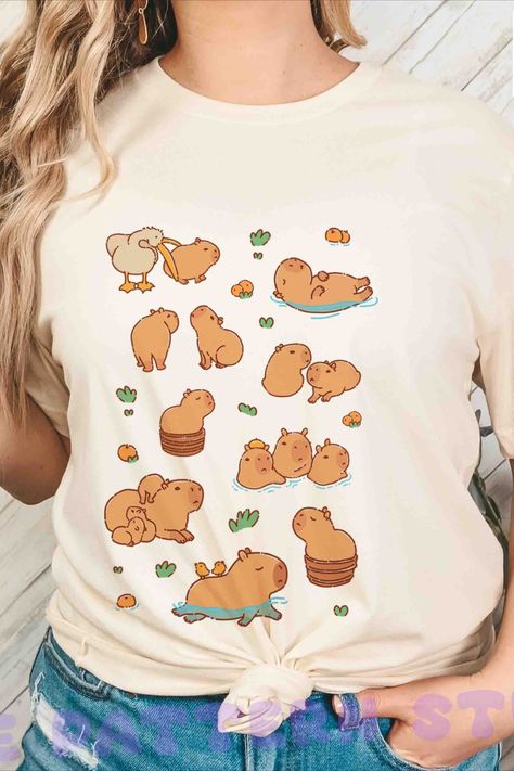 A shirt with capybaras, there're capys swimming, relaxing, lying around, sitting in a Japanese round tub, being eaten by a pelican... a perfect gift for capybara loves. Capybara Costume For Human, Capybara Illustration, On My Puter Capybara, Capybara Clothes, Capybara Wearing Glasses, Capybara On Computer, Capybara Memes Funny, Capybara Shirt, Goofy Face