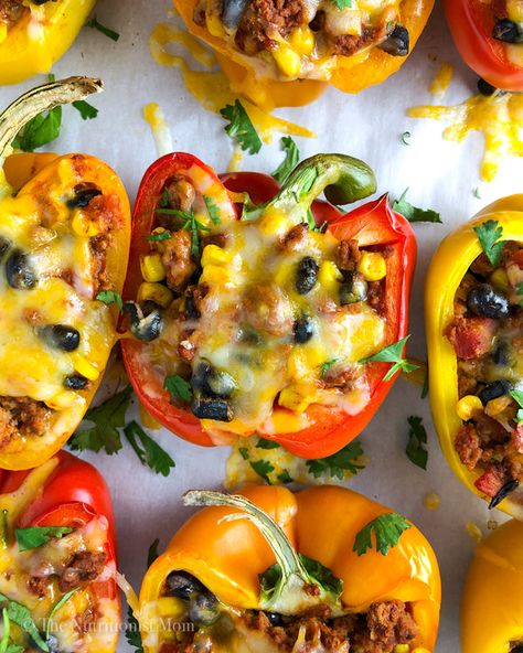 These Taco Turkey Stuffed Peppers are perfect for when you’re craving tacos but want something a little more filling. Think taco-seasoned turkey with sweet corn and black beans, stuffed inside a perfectly roasted pepper and smothered wit... Stuffed Bell Peppers Turkey, Corn And Black Beans, Turkey Stuffed Peppers, Taco Stuffed Peppers, Pepper Sandwich, Protein Mug Cakes, Stuffed Peppers Turkey, Canning Sweet Corn, Bell Pepper Recipes