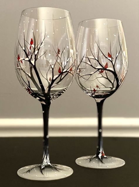 Cardinal Wine Glass Hand Painted Red Spirit Bird Snowy Tree Branches Seasonal Holiday Winter Glassware Collectible Visitor From Heaven Gift Snuggle up next to the fire and warm up your winter with these seasonal Winter Wine Collection!  Snow capped trees with birds nestled in the branches while snow falls all around the base.  This is by far one of my most talked about glasses.  Have you ever heard the cardinal is a visitor from heaven?  You would not believe the stories I have heard from my cus Drawing On Glass Ideas, Christmas Glass Art, Wine Glasses Painted, Decorating Wine Glasses, Painted Glasses Christmas, Painted Wine Glasses Ideas, Holiday Painted Wine Glasses, Wine Glass Painting, Mountain Painted Wine Glasses