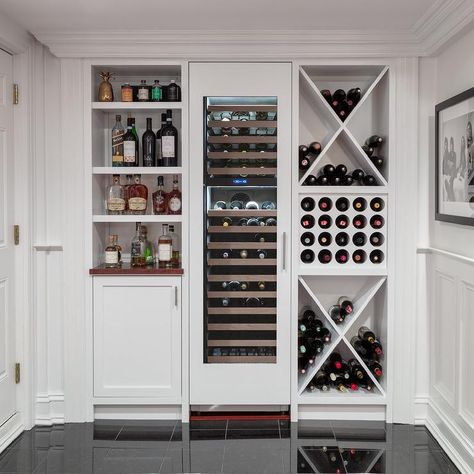 Basement with built-in wine racks and white cabinets finished with nickel hardware storing wine and beverages and spirits. White Bar Cabinet, Bar Cabinet Design, Built In Wine Rack, Home Bar Design, Colonial Style Homes, White Bar, Diy Wine Rack, Rack Design, Diy Wine