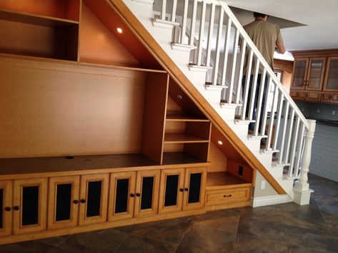 Solution for Open Space under Staircase: This is double sided with entertainment center on one side and book/linen storage on the other. Living Room Under Stairs, Design Under Stairs, Interior Design Under Stairs, Cabinet Under Stairs, Room Under Stairs, Space Under Stairs, تحت الدرج, Vitrine Design, Staircase Storage