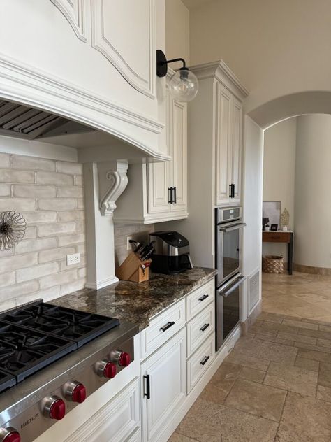 Learn which countertops are the most timeless. Shown in this 2000s, Tuscan style kitchen, cream cabinets, taupe subway tile backsplash, travertine tile floor, granite countertop.   #kyliem #kitchenremodel #kitchen #cabinets #diy #sherwinwilliams #benjaminmoore #counters #countertop #granite #quartz Cream Cabinets With Dark Countertops, Alabaster Kitchen Cabinets With Granite, Travertine Kitchen Countertops, White Cabinet Brown Granite, Tuscan Style Kitchen, Black Granite Kitchen Countertops, Countertop Granite, Gray Quartz Countertops, Black Granite Kitchen