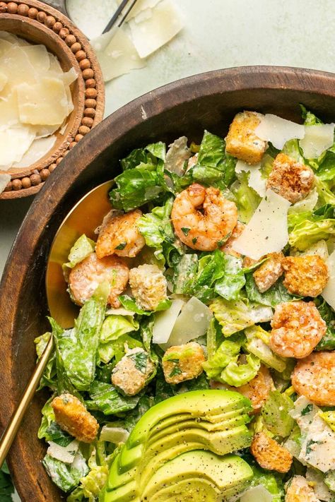 This delicious Shrimp Caesar salad showcases juicy shrimp, seasoned and cooked with a simple spice blend, mixed with crunchy romaine lettuce, creamy avocado, Parmesan cheese, and crispy croutons, all tossed in a homemade, high-protein, creamy Caesar dressing. Ready to enjoy in under 30 minutes! Shrimp Caesar Salad, Caesar Salads, Creamy Caesar Dressing, Salad Shrimp, Juicy Shrimp, Caesar Salad Recipe, Romaine Lettuce Salad, Caesar Dressing, Easy Shrimp