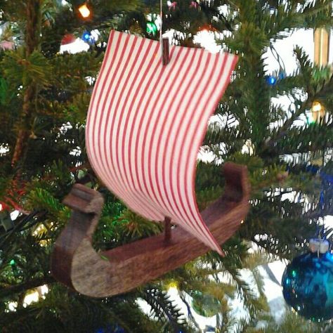 "This viking ship ornament is made of WOOD with a red hull and stiffened, red and white striped fabric sails.   A great ornament for your Christmas tree or for the person in your life who is a Viking at heart.   If you love anything viking, this unique ornament is for you.  BE BOLD, BE A VIKING! Dimensions:   4 1/2\" tall x 3 3/4\" w x 4 3/4\" l,  Approx. Brown  hulled viking ships are also available at my shop.   See a version of a viking ship mobile on Youtube.  Use tag:  Toymakertothekings.co Viking Cottage, Viking Yule, Ship Mobile, Woodshop Projects, Yule Traditions, Themed Trees, Viking Ornament, Viking Christmas, Yule Tide