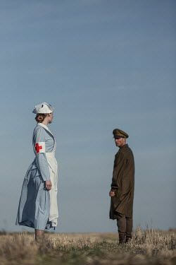 Magdalena Russocka Soldier and nurse standing in field Nurse And Soldier Couple, Nurse And Soldier, People Running In A Field, Soldier Running, Values Reference, Soldier Carrying Wounded, 1940s Soldier And Wife, Reference Pose, Romance Covers Art