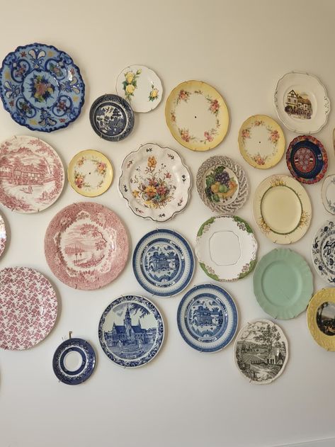 The vintage plates are all sourced from thrift stores.  Credit: Collette China Plate Gallery Wall, Plates On Wall In Bedroom, Vintage Plate Wall Decor, Vintage Coastal Kitchen, Plate Gallery Wall, Thrifted Dishware, Thrifted Wall Decor, Yellow Kitchen Floor, Antique Plates On Wall