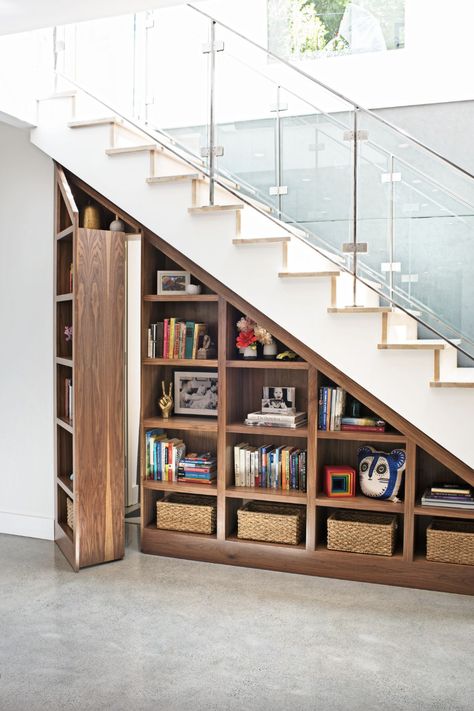 a bookshelf with books and a basket on it Door Under Stairs, Stair Bookshelf, Stairs Furniture, Architecture Room, Stair Shelves, تحت الدرج, Murphy Door, Stairs Renovation, Secret Hideaway