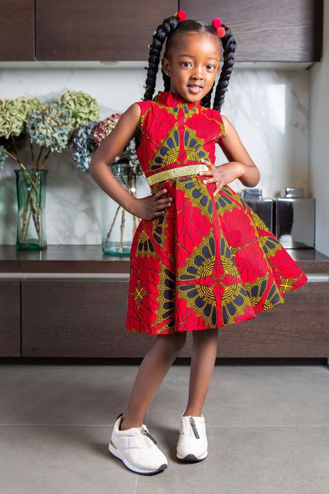 African Print Dress for Girls | Sleeveless Turtleneck Midi Red & Gold Party Dress for Girls - CORDELIA Our iconic Turtleneck style and our Sleeveless Turtleneck Midi Dress for Girls is exactly what you need when you want only the very best for your Girls. Featuring a tulle underskirt for extra flare and a vibrant Ankara pattern, this African Print Dress for Girls is perfect for stylish culture representation at every occasion, including weddings, photoshoots & birthday parties! There's never bee African Traditional Dresses For Kids Girl, Ankara Dress For Girl Child, Children's Ankara Dress Styles, Children African Dresses, Ankara Dress Styles For Children, Girls Traditional Dresses, Kids African Dresses, African Attire For Kids, Chitenge Patterns