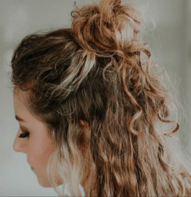 35 Best Half-Up Bun Hairstyles That Don't Look Messy | YourTango Half Up Hairstyles Wavy Hair, Half Up Bun Curly Hair, Half Up Half Down Bun Curly Hair, Half Up Curly Hairstyles, Curly Hair Bun Styles, Messy Bun Curly Hair, Half Bun Hairstyle, Half Up Curly Hair, Half French Braids