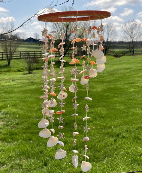 Let these beautiful seashell windchimes take you far, far away to a sunny beach with the sound of shells tinkering on the shore. These windchimes are surely one-of-a-kind, and they are as unique as you are! Add charm, flair, and a bit of magic to your day with these windchimes!! They are made with genuine seashells that are embellished with starfish beads and shell chip beads to truly capture the essence of the beach. The longest strand measures approximately 14 inches in length. Since each piec Seashell Windchime Diy, Things To Do With Shells, Windchimes Homemade, Things To Do With Sea Shells, Seashell Windchimes, Shell Windchimes, Seashell Mobile, Seashell Wind Chime, Seashell Chandelier