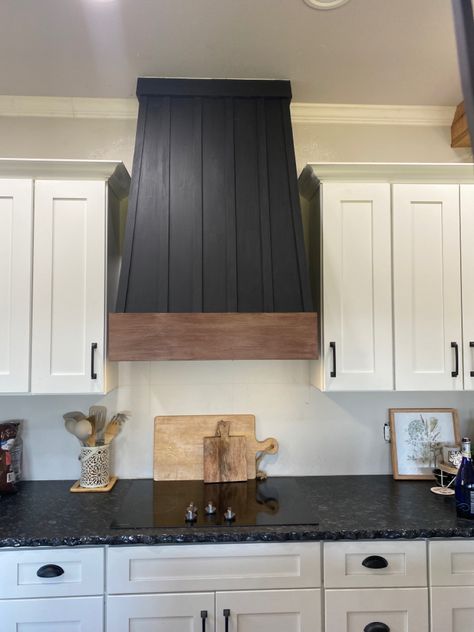 Black DIY vent hood with wooden stained trim Black Shiplap Range Hood, Black Hood Vents Kitchen, Black Wood Range Hood Cover, Black Range Hood White Kitchen Wood, Stained Shiplap Range Hood, Black Hood Vent With Stained Cabinet, Dark Painted Kitchen Cabinets, Wood Hood Vent Cover, Diy Vent Hood