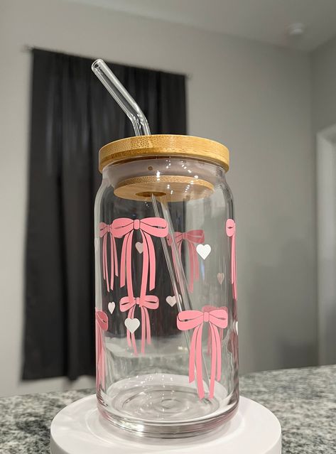 Step into elegance and grace with our Pink Ribbon 16oz Glass Cup. Whether you're savoring your morning iced coffee, enjoying a mid-afternoon ice tea break, this cup adds a touch of sophistication to every sip. It's not just a cup--it's a symbol of grace, strength, and the pursuit of beauty in every moment. Cup Decoration Ideas, Glass For Water, Morning Iced Coffee, Glass Tumbler Design, Kawaii Cups, Cricket Crafts, Stationery Obsession, Bamboo Cups, Mid Afternoon