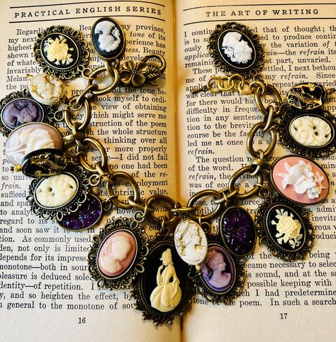 Victorian Style Cameo Charm Bracelet ~ Vintage and New Cameos. Hand crafted Charm Bracelet all done in Ivory, cream, pale pinks, lavender. with  IVORY Victorian lady.   Cream with gold etched lucite lady cameos.  Vintage resin cameo ladies.  Vintage Hong Kong Cream colored resin flowered cabochons.  The bracelet is made of vintage brass chain.  Ending with a vintage style lobster clasp.  . It is 7 3/4"s can extend to a little over 8"s. It is 2"s wide. Can be lengthened or shortened. Comes gift b Victorian Style Adjustable Cameo Jewelry, Victorian Adjustable Cameo Jewelry, Victorian Charm Bracelet, Luxury Victorian Cameo Bracelet, Victorian Bracelet With Vintage Charm, Charm Bracelet Vintage, Vintage Hong Kong, Sales Ideas, Vintage Charm Bracelet