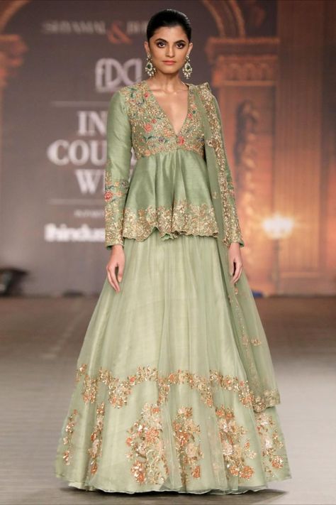 A stylish muted olive Peplum jacket embroidered with beautiful resham aari & water colour sequins, teamed with a sheer organza lehenga. Visualization Board, Designer Bridal Lehenga Choli, Sabyasachi Lehenga, Bridal Lehenga Collection, Ritu Kumar, Designer Bridal Lehenga, Anita Dongre, Wedding Blouse Designs, Lehenga Collection