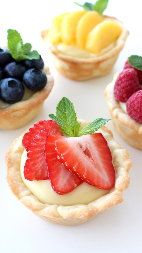 Recipe with video instructions: A twist on regular fruit tarts — the crust is actually a cookie!      Ingredients: 1/2 recipe Cookie Dough, 4 egg yolks , 1/2 cup sugar , 1/4 cup cornstarch , pinch of salt , 2 cups milk , 1 1/2 tsp vanilla extract, your desired fruit , fresh mint leaves , confectioner’s sugar, for dusting (optional) Cookie Crust Recipe, Mini Fruit Tarts, Fruit Tart Recipe, Sugar Cookie Crust, Fruit Tarts, Mini Tart, Cookie Crust, Fruit Tart, Tart Recipes