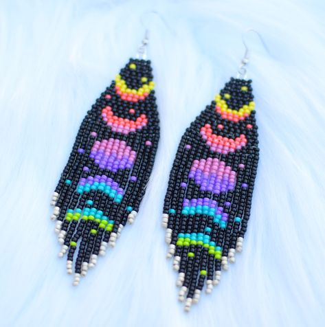 These beautiful handmade rainbow moon cycle seed bead fringe earrings are sure to be the statement piece of your outfit. The perfect accent for any occasion. Made with high quality round glass seed beads, hypoallergenic earring hooks and lots of love. Earrings are 4.25 inches long from ear lobe and 1 inch wide. Pair pictured is completed and will ship within 3-5 business days.  Please reach out with questions or custom earring requests.  *Purchase 3 items from Color My World Artistry and automatically receive 15% off your order.* Colorful Beaded Earrings, Beaded Fringe Earrings Pattern Brick Stitch, Seed Beaded Earrings, Rainbow Fringe Earrings, Bohemian Rainbow Beaded Earrings With Fringe, Moon Fringe Earrings, Moon Brick Stitch Earrings, Unique Multicolor Beaded Fringe Earrings, Fringe Earrings Diy