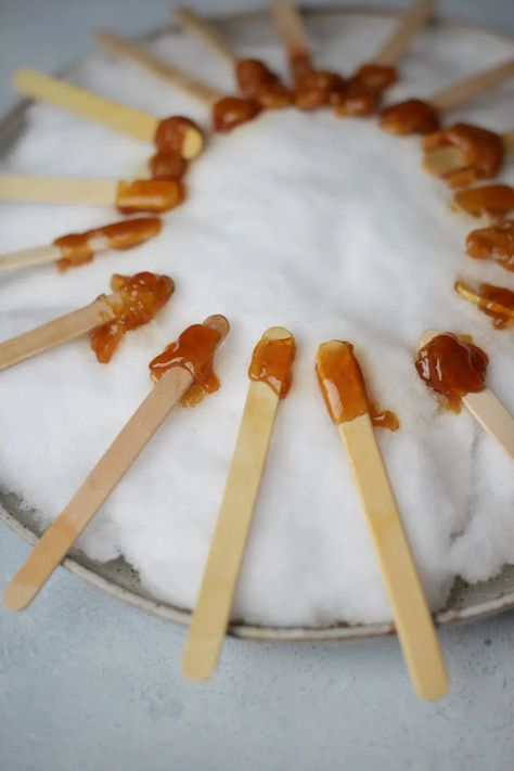 A tradition in the Northeast and Canada during maple sugaring season, maple syrup taffy on snow is a sweet winter treat that everyone loves! | fareisle.com Maple Syrup On Snow, Maple Taffy, Taffy Recipe, Snow Recipe, Maple Sugaring, Maple Candy, Winter Treats, Taffy, Small Bites