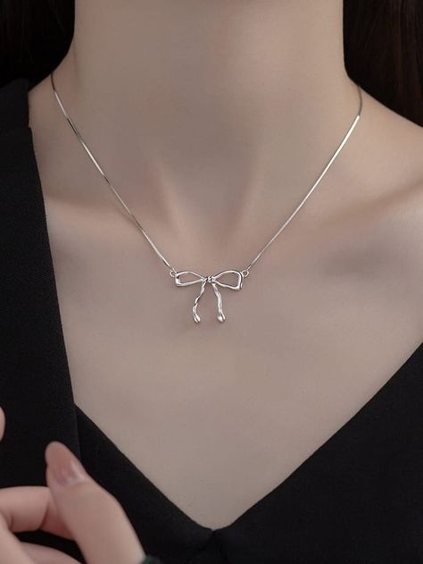 coquette BOW NECKLACE ✨ You are art.. We just accessorize it! Meet DAPHNE Dainty silver snake chain necklace with a perfect bow pendant. Layers wonderfully in a collection or beautiful as a stand alone piece! High quality fine art jewelry made from recycled materials when available Pure 925 sterling silver with 18k gold plating Chain Length 16 inch (40cm + 5cm) Care instructions: To maintain the beauty of your items please remove items before exercising, swimming and showering. It is recommended Cute Silver Accessories, Cute Jewelry Necklaces Silver, Bow Necklace Aesthetic, Bow Pendant Necklace, Cute Necklace Silver, Silver Bow Jewelry, Cute Silver Necklace, Silver Bow Necklace, Silver Dainty Jewelry