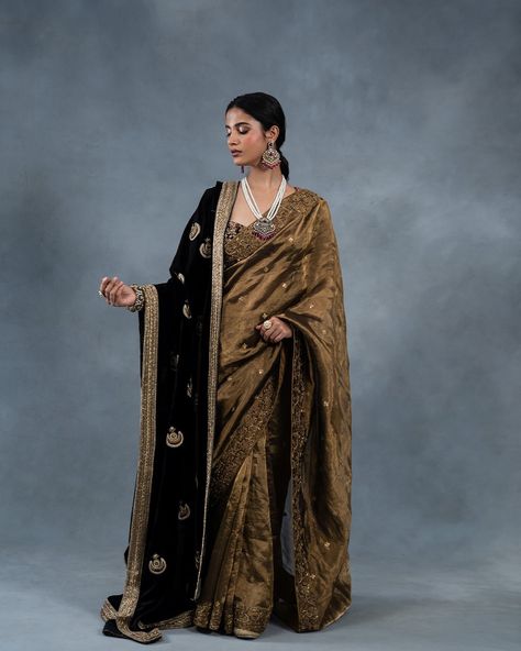 Introducing our Silk Velvet Chand Bali Dushala, a luxurious masterpiece of traditional craftsmanship. Adorned with intricate hand-embroidered Zardozi work, this exquisite shawl features a rich antique gold border, infusing opulence and elegance into any ensemble. Visit us at B-25, Defence Colony, New Delhi. We look forward to your presence. www.richaahluwalia.com/collection/chandbali-black-doshala-wedding-saree/ To schedule an appointment or arrange a video call, please dial +91 8800880840.... Saree With Velvet Shawl, Saree With Shawl, Suit With Shawl, Tangled Wedding, Saree Styling, Chand Bali, Velvet Saree, Saree Wearing Styles, Saree Wearing