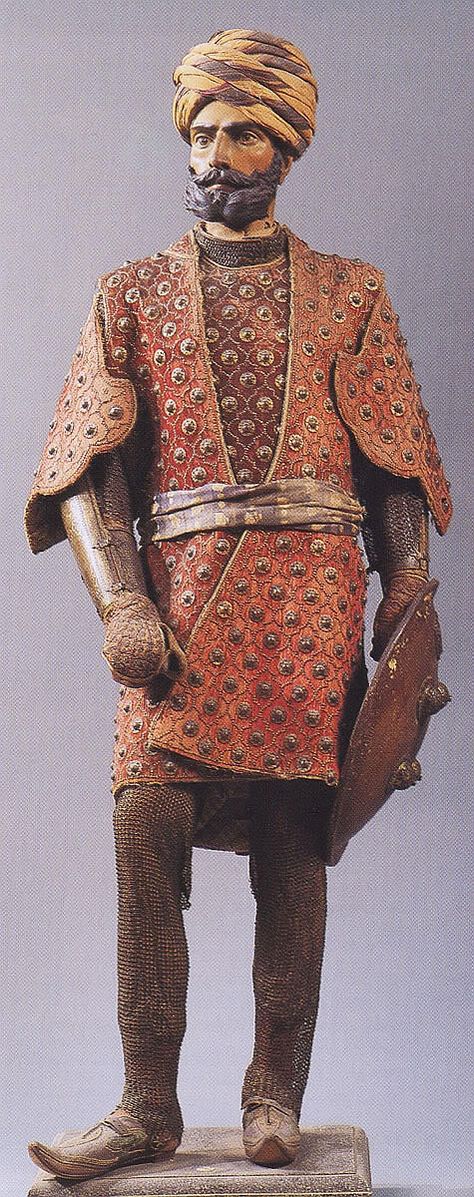 Chilta hazar masha (Coat of a thousand nails), bazu band (arm guards), zirah pajama (mail trousers), dhal (shield). Indian armored clothing made from layers of fabric faced with velvet and studded with numerous small brass nails, which were often gilded. Fabric armor was very popular in India because metal became very hot under the Indian sun. Stibbert Museum, Florence Italy. Fantasy Culture, Armor Reference, Arm Guards, Costume Armour, Body Armour, Armor Clothing, Ancient Armor, Mughal Empire, Historical Armor