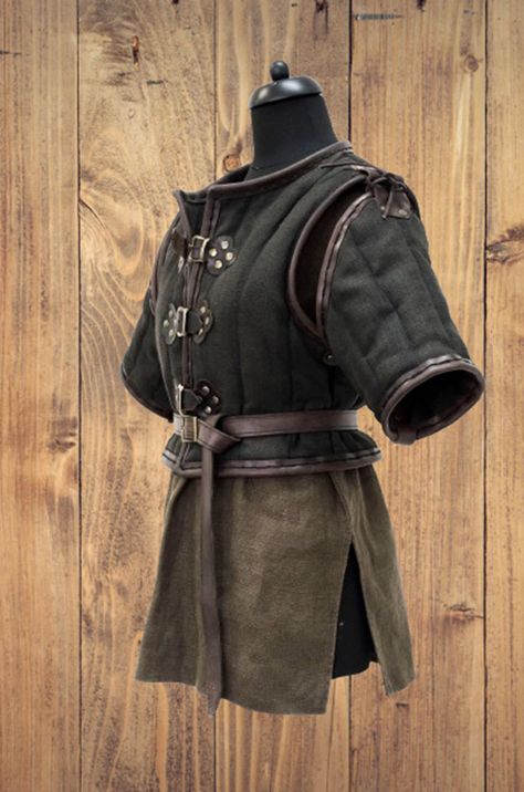 Medieval Thick Padded Gambeson. Materials: Pure Cotton, Leather. Size Details:- X-Small:- 29"- 32", waist:- 26" Small:- 30"- 34" waist:- 27"- 28" Medium:- 34"- 38", waist:- 29"-30" Large:- 38"- 42", waist:- 31.5"-33" X Large :- 42"- 46", waist:- 33"-34.5" XX Large :- 46"- 50", waist:- 36" Note: We are customized all size Blacksmith Outfit Male, Authentic Medieval Clothing, Leather Gambeson, Medieval Fantasy Clothing Art, Medieval Aesthetic Outfit, Medieval Clothing Male, Medieval Clothing Men, Medieval Fantasy Clothing, Medieval Gambeson