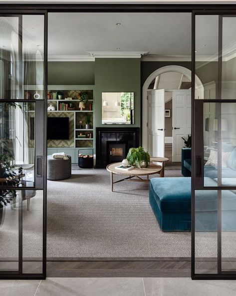 Glass doors are an excellent way to divide a large living space, especially in an open-plan area where one space needs to serve multiple functions. In this fabulous family room, designed by Studio Hooton, custom sliding Crittall doors have been used to separate the living area from the kitchen, creating distinct zones that feel separate but are still visually connected. Dividing Open Plan Living, Crittal Doors Lounge, Kitchen Living Room Glass Divider, Crittal Doors Sliding, Opening Between Kitchen And Living Room, Internal French Doors Room Dividers, Internal Glazed Room Dividers, Separate Kitchen And Living Room, Kitchen Living Area Open Plan