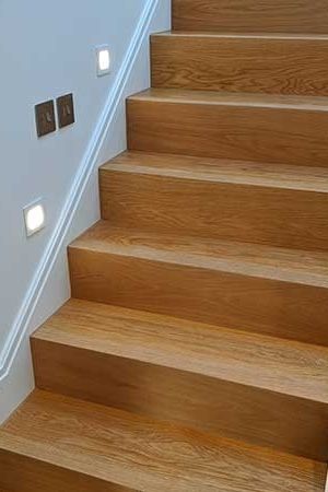 For this project, the two-bed flat was broken into different levels, divided by sets of stairs. In total we clad over 55 steps in oak.   More information about our work on stair cladding can be found on our website. Engineered Wood Stairs, Classic Oak Beige Quick Step, Oak And Glass Staircase, Classic Oak Natural Quick Step, Glass Oak Staircase, Oak Stair Treads White Risers, Wood Floor Stairs, Stairs Cladding, Engineered Wood Floors Oak