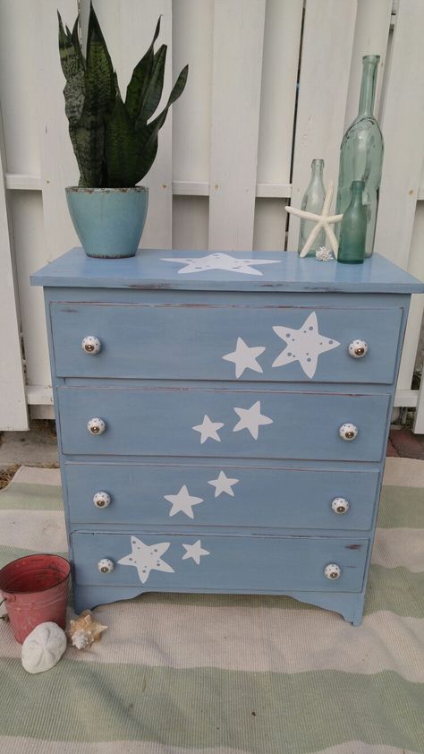 Little Star dresser.  Solid wood dresser painted in Annie Sloan Louis Blue, distressed and finished with a soft wax.  A wave of stars flow across the front with a large star on the top.  The knobs are white porcelain with blue stars on them. Nursery Dresser Paint Ideas, Cute Designs To Paint, Coat Hook Ideas, Annie Sloan Louis Blue, Starry Night Bedroom, Childrens Dresser, Painted Garden Furniture, Designs To Paint, New Jersey House