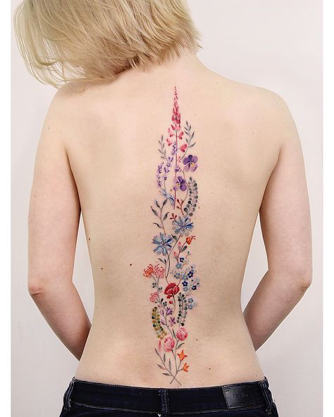 Image may contain: one or more people Colorful Flower Spine Tattoo, Spine Tattoos Colorful, Color Spine Tattoo, Colorful Spine Tattoo, Floral Spine Tattoos For Women, Flower Spine Tattoos, Spine Tattoos For Women, Spine Tattoo, Spine Tattoos