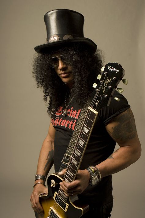 Saul Hudson, better known by his stage name Slash, is the current lead guitarist of hard rock band Guns N' Roses.  Slash was married on October 10th, 1992 to his first wife Renee Suran in California. The model-actress divorced Slash in 1997 following five years of marriage. Following this, Slash married for a second time to Perla Ferrar on October 15th, 2001 in Hawaii. The couple have two sons. On August 28th 2002, Perla gave birth to their first son, London Emilio. Their second son Cash ... Apetite For Destruction, Use Your Illusion Ii, Saul Hudson, Velvet Revolver, Duff Mckagan, Hair Metal, Written In The Stars, British American, Glam Hair