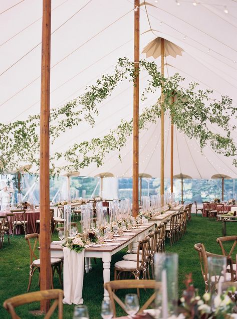 sailcloth tent wedding with farmhouse tables and suspended greenery Greenery In Wedding Tent, Garden Tent Wedding Reception, Tent Wedding Greenery, Sailcloth Tent Wedding Lighting, Greenery Tent Entrance, Tent Wedding Fall, 40x80 Tent Layout Wedding Ideas, Sailcloth Wedding Tent, Sailcloth Tent Wedding Decor