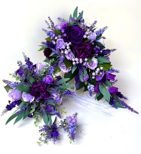 Bridal teardrop bouquet 45 cm long and 27 cm across . Finish with white ribbons  Bridesmaids bouquet 23 cm across , finish with purple ribbon We have two styles of buttonhole available . Purple Bridal Bouquet Real Flowers, Blue Purple Bouquet Wedding, Wedding Flowers Purple And White, Green And Purple Fall Wedding, Purple Grey Wedding, Purple And White Bouquet, Purple Bride Bouquet, Wedding Bouquet Purple, Bridal Bouquet Purple