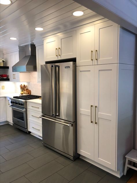 Clean white kitchen with stainless appliances and brass fixtures Kitchen Remodel Stainless Steel Appliances, White Kitchen With Silver Appliances, Stainless Steel Appliances Gold Hardware, Kitchen With Beams, Kitchen Remodel Stainless Steel, Clean White Kitchen, White Cupboards, Black Appliances, Gold Kitchen