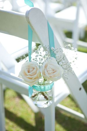 roses in mason jars with aqua ribbon wedding chair decoration ideas for beach weddings ขวดโหล Mason Jar, Beach Wedding Decorations Reception, Aqua Wedding, Wedding Chair Decorations, Wedding Beach Ceremony, Turquoise Wedding, Teal Wedding, Mason Jar Wedding, Beach Wedding Decorations