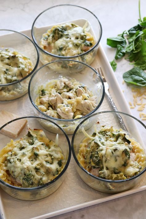 Spinach Artichoke Chicken Orzo Bakes - Stay Fit Mom Stay Fit Mom Spinach Artichoke, Chicken Orzo Meal Prep, Spinach Artichoke Chicken Orzo, Chicken Artichoke Orzo, 2b Mindset Lunches, Spinach Artichoke Chicken Orzo Bake, Stay Fit Mom Recipes Meal Prep, Stay Fit Mom Meal Prep, Orzo Meal Prep